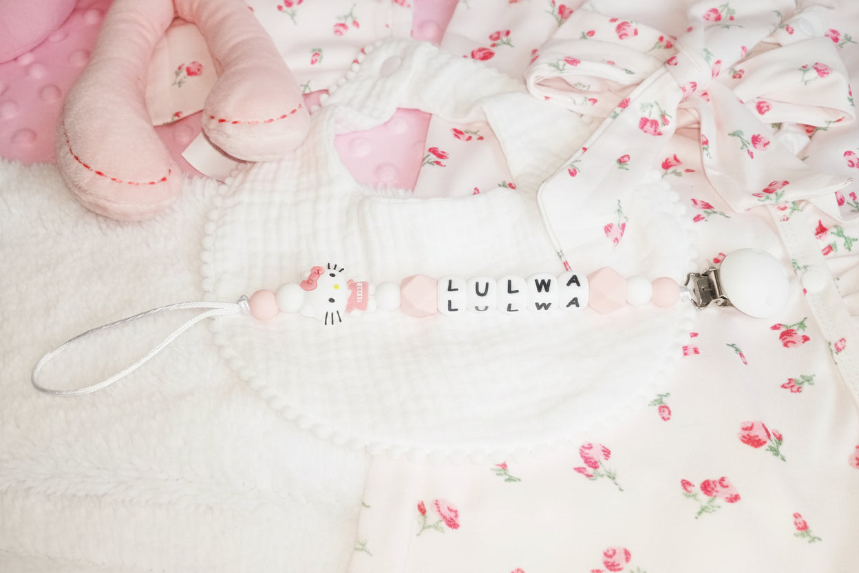 Baby mask with 'LULWA' branding on a floral blanket
